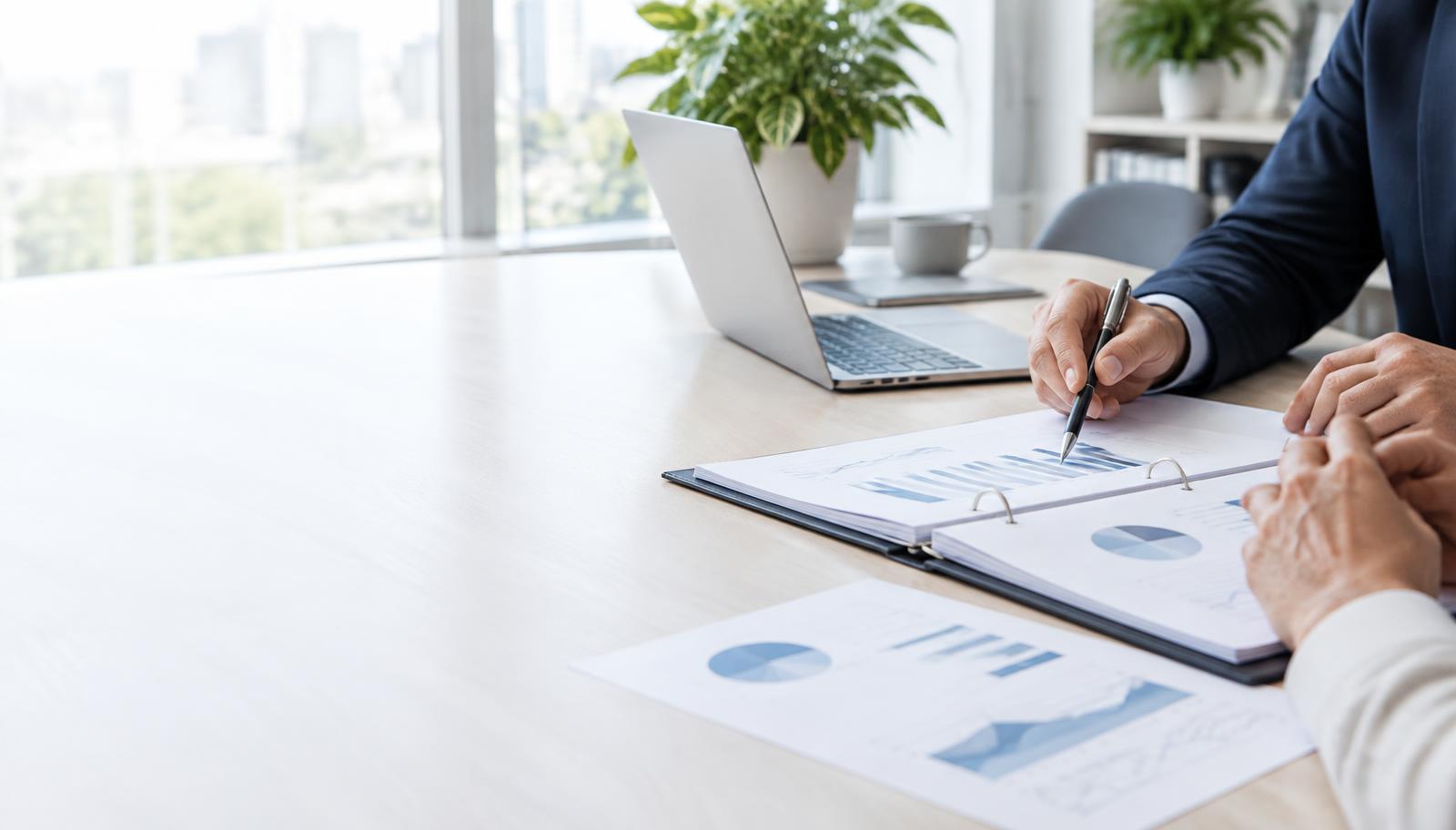 Illustrative business owner and adviser reviewing financial records for an independent business valuation